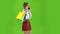 Girl steps around with packages and talks. Green screen. Side view