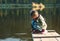 Girl with a stick on a pier