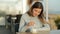 Girl stirring coffee sitting in a restaurant in slow motion