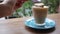 girl stirring latte with spoon and eating foam