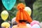 girl in a strange orange pumpkin-colored hat on the City Day holiday. In the background, colorful air balloons