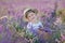 Girl in a straw hat in a field of lavender with a basket of lavender. A girl in a lavender field. Girl with a bouquet of lavender.