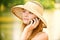 Girl in straw hat with phone