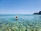 The girl in a straw hat swims in Navarone Bay on Rhodes island, Greece