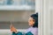 girl on the street with mobile phone on the wall