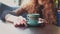 Girl with stripped ceramic cup of herbal tea served in front of her on saucer, shaky handheld shot