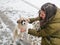 Girl stroking a puppy on the street. winter and pets. Teenager girl hug puppy shepherd dog close up photo