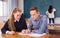 Girl student explaining study material to classmate