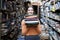 Girl student holds a stack of books in the library, she searches for literature and offers to read, a woman prepares for study,