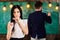 Girl student play with eyeglasses while teacher writes on chalkboard. Lady on dreamy face not pay attention to teacher