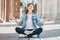 Girl student sitting on the floor and meditating