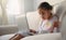 Girl student  sitting at the table, writing homework . Teen using laptop computer to study.New normal.Social distancing.stay home