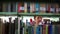 Girl student walking between shelves, searching for books