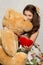 Girl with stuffed heart and bear