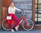 Girl, style, leisure and lifestyle - happy young hipster woman with handbag and red vintage bike eating ice cream on city street