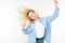 Girl in a stylish image waving her hair and dancing on a white studio background