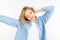 Girl in a stylish image waving her hair and dancing on a white studio background