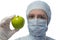 Girl in a suit laboratory shows green apple