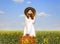 Girl with suitcase at spring rapeseed field.