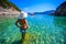 Girl with sun hat relaxing and swimming at Porto Timoni beach at Afionas is a paradise double beach with crystal clear azure water