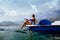 Girl sunbathe in sea on paddle boat catamaran