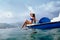 Girl sunbathe in sea on paddle boat catamaran