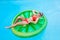 Girl sunbathing on inflatable in pool