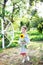 Girl with a sunflower. Happy child with walks in the garden. Portrait of a charming little girl with a sunflower. The concept of c