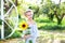 Girl with sunflower. Happy child with walks in summer park. Portrait of charming little girl with a sunflower. concept of childhoo