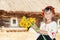 Girl with sunflowers and Hutsul wreath in the village with old wooden house