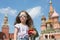 Girl in sunglasses and jeans with suspenders with miniature cathedral