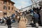 Girl in sunglasses makes selfie on stairs with people background at Spain square at Roma capital of Italy in february 2018.