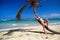 Girl in sunglasses resting on a palm, taking sunta