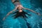 A girl in sunglasses swims in the pool. Beautiful woman resting in the water in the outdoor pool