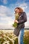 Girl in sunny field with camomiles