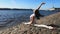 The girl on a sunny morning is engaged in fitness stretching on the embankment