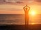 Girl at sunset practicing yoga at the seashore, silhouette