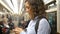 Girl surfs Internet standing in underground carriage