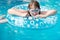 Girl in swim goggle on inflatable circle