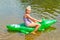 Girl swimming in the river with inflatable crocodile