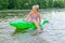 Girl swimming in the river with inflatable crocodile