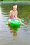 Girl swimming in the river with inflatable crocodile