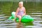 Girl swimming in the river with inflatable crocodile