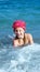 Girl swimming in the sea and playing in the coastal strip