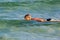 Girl swimming on the sea waves in the rays of summer