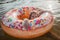 Girl swims with big donut inflatable ring on lake on hot summer day, happy summertime, cottagecore