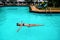 Girl swims in the pool in the rain