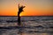 The girl swims in the sea, splashes in the water at sunset. Relaxation and happy pastime. Summer vacations