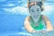 Girl swims in swimming pool underwater, happy active teenager dives and has fun under water, kid fitness on family vacation