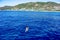 Girl swims towards the shore of Alanya Turkey being far from the coast in the sea. Woman lies on the surface of blue water